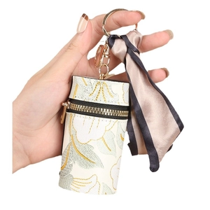 Monedero cilíndrico floral con cremallera dorada y llavero decorativo de pañuelo