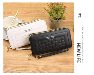 Detailed view of quilted shell-patterned long wallets in black and white with wrist straps