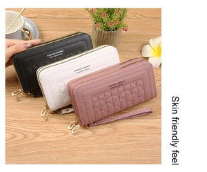 Detailed view of quilted long wallets in black, white, and pink with dual zippers