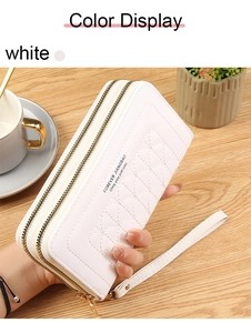 Detailed view of white heart-embossed long wallet with dual zippers and wrist strap
