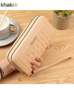 Detailed close-up of khaki embroidered phone wallet with dual zippers and hand strap