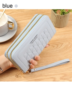 Detail of light blue leather wallet with scalloped stitching and double zippers
