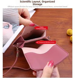 Detail view of pink crossbody phone bag showing internal main pocket and clear window slot