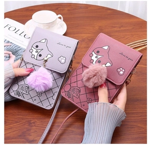 Detail of cross body phone bags with fox print and plush ball in purple and red