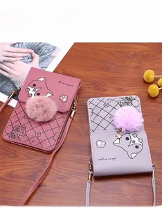 Detailed view of mini pink and purple phone bags with cartoon fox print and pom-pom decor
