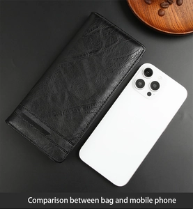 Size comparison of long leather wallet and mobile phone on a minimalist gray background