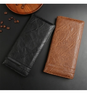 Detail of long men's wallets showing black and brown textured leather with embossed stripes