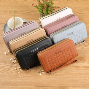 Multi-color women's long wallets with dual zippers and quilted patterns on a desk