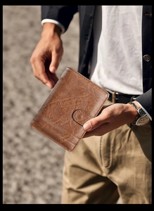 Close-up of vintage brown PU leather tri-fold wallet with card slots and stitching