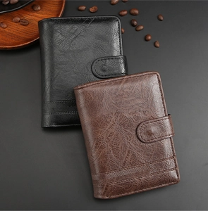 Detail of vintage PU leather tri-fold wallets in black and brown with coffee bean decor