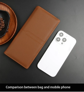 Size comparison between a brown pebbled leather long wallet and a white smartphone