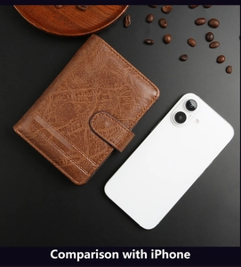Brown vintage leather trifold wallet size comparison with an iPhone on a dark table