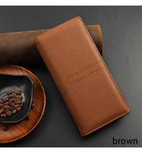 Close-up of brown pebbled leather texture and hand-stitched edges on a men's long wallet