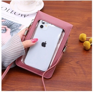 Vertical rose pink crossbody cell phone bag with transparent touch screen window on wood