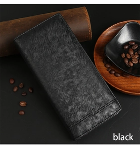 Detail of black long bifold wallet showing premium litchi grain texture in business setting