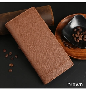 Detail of brown litchi pattern leather wallet with fine stitching on dark background