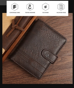 Detail view of dark brown litchi grain leather wallet with retro embossed lines on wood