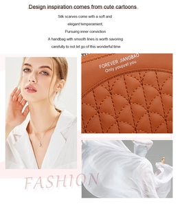 Detail of brown litchi leather bag with quilted stitching and a silver diamond pendant