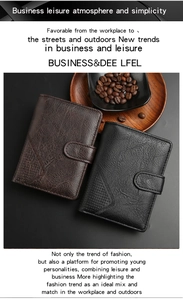 Detail of pebbled leather bifold wallets with snap closure and wood background
