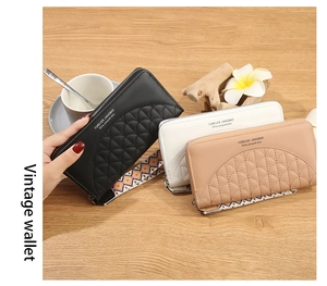 Close-up of vintage quilted leather wallets with wrist straps and elegant floral decor