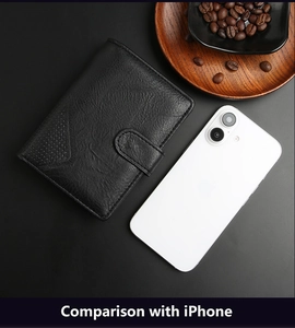 Detailed view of black leather wallet next to a smartphone for size comparison