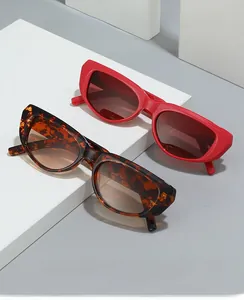 Detail of trendy rectangle sunglasses in red and leopard print on minimalist geometric props