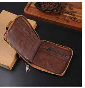 Detailed interior of vintage brown leather wallet showing card slots and zipper pocket