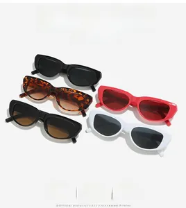 Detail of five cat-eye sunglasses in black, tortoiseshell, red, and white frames