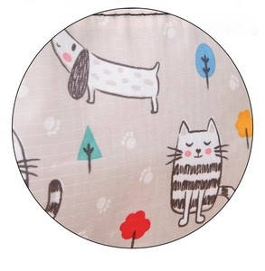 Close-up of durable oxford fabric with colorful hand-drawn cartoon dog and tree prints