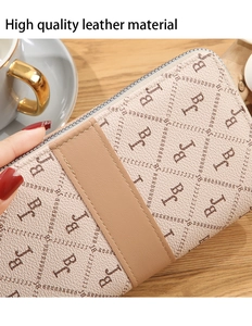 Close-up of high quality beige leather wallet with brown letter print and fine stitching