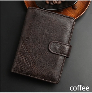 Detailed view of coffee leather wallet with vintage texture and button closure