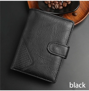 Close-up of black leather men's wallet with embossed texture and snap closure