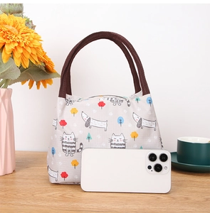 Insulated lunch bag with cartoon cat pattern and durable brown woven handles and zipper