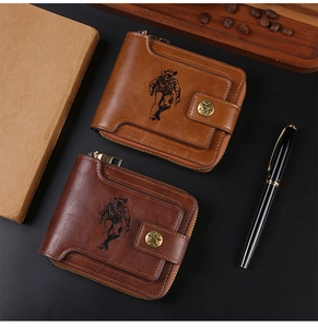 Detail view of vintage men's wallets in brown leather with cowboy embossing and star button