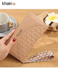 Detail of khaki leather long wallet featuring quilted fish scale pattern and woven handle