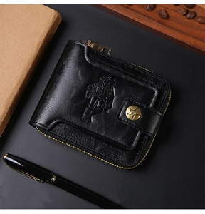 Macro detail of black leather wallet featuring vintage embossed figure and star metal badge