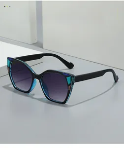 Detail of cat eye sunglasses with blue geometric accents and purple gradient lenses