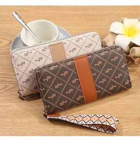 Close-up of long zip wallets with BC monogram pattern and ethnic style wrist straps
