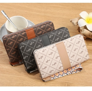 Three long zip-around wallets with BJ monogram pattern in brown, black and cream colors