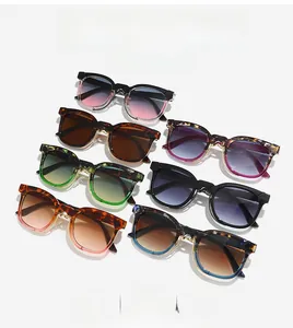 Flat lay of vintage oversized sunglasses in assorted frame colors with gradient lenses