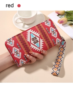 Detail of red Bohemian wallet with geometric patterns and matching wrist strap