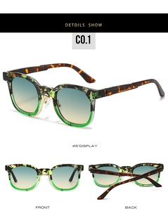 Detail showing two-tone tortoiseshell and green sunglasses with gradient lenses