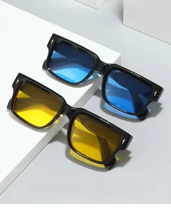 Detail of 2024 square eyewear with thick black frames and gold arrow metal accents