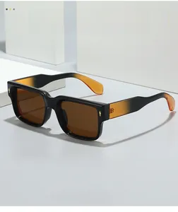 Detail of square sunglasses with orange gradient temples and golden rhombus accents