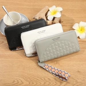 Three long zip wallets in black, beige, and green with stylish geometric wrist straps