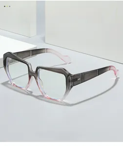 Detail of grey to pink gradient thick frame glasses with golden hinge ornaments