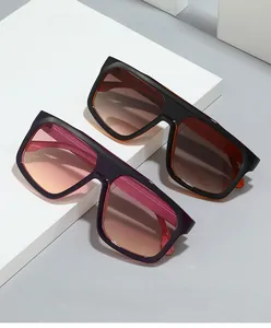 Macro detail of 2024 futuristic oversized sunglasses with gradient lenses on white display