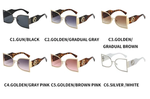 Close-up of semi-round metal frame sunglasses with decorative openwork logo on temples