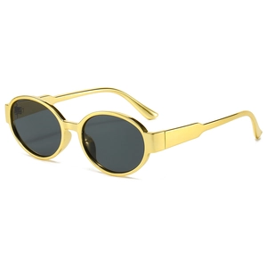 Modern oval sunglasses with vintage gold metal frame and dark lenses on white background