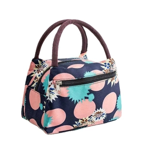 Portable thermal lunch bag with blue floral print and dual handles for food storage